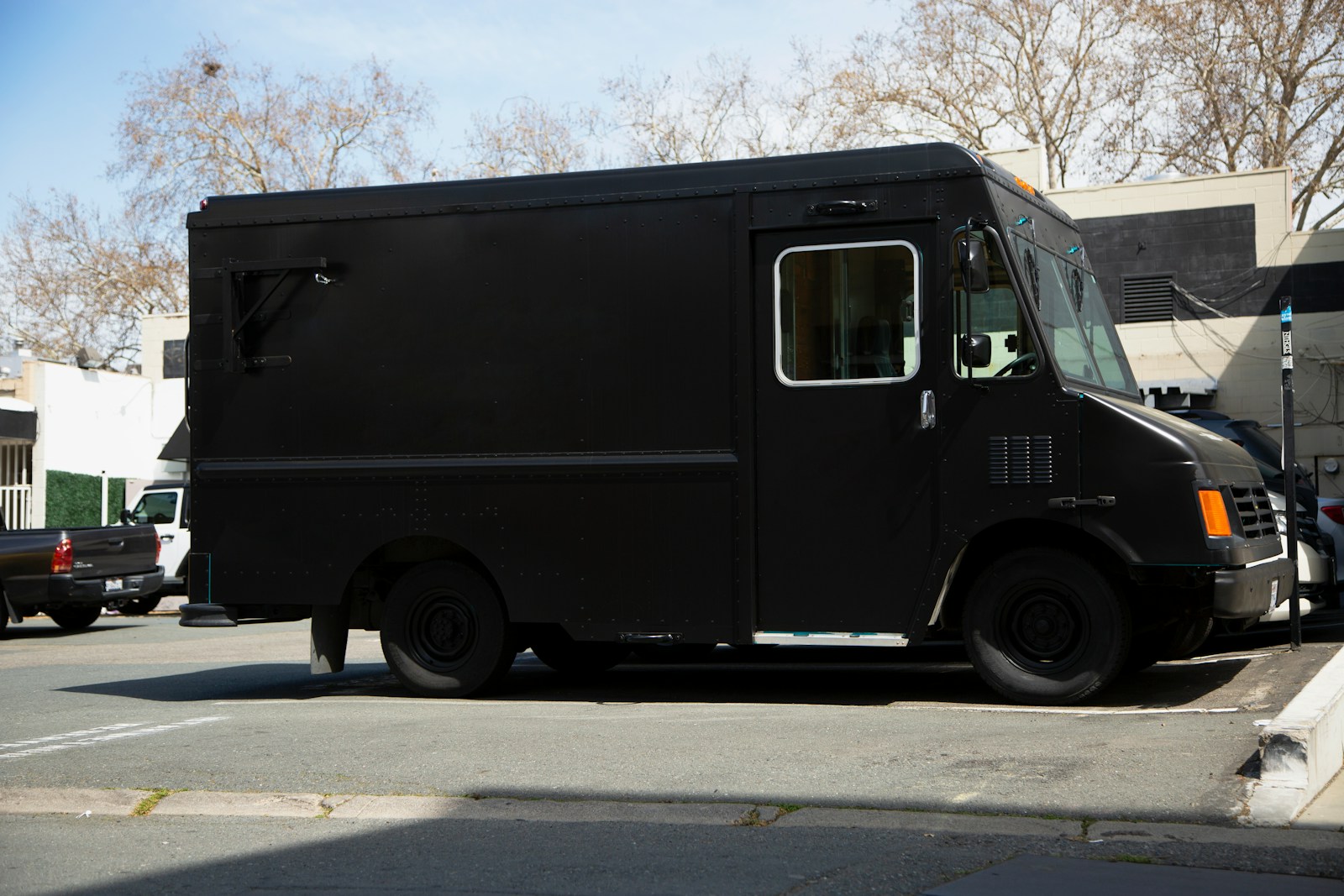 black van on gray asphalt road during daytime